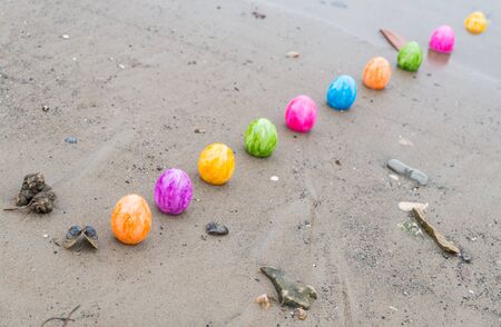 Colorful Easter eggs on a riverbankの写真素材
