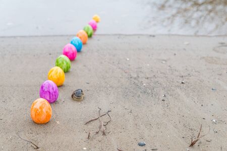 Colorful Easter eggs on a riverbankの写真素材