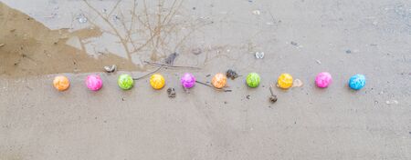 Colorful Easter eggs on a riverbankの写真素材