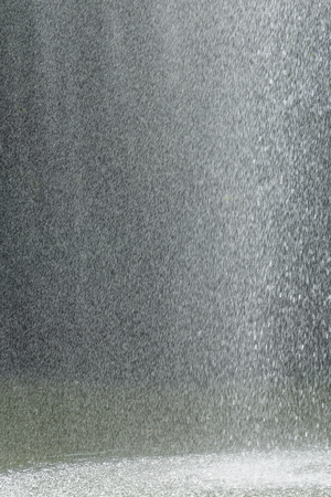 Closeup of a water fountain in the middle of a lakeの写真素材