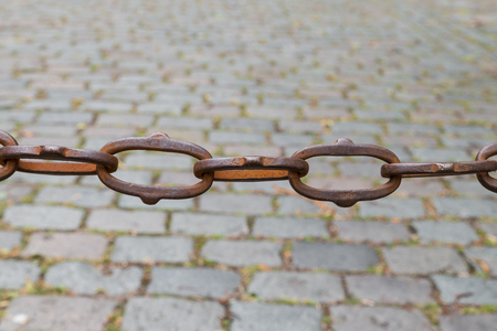 Rusty chain cobblestones in the backgroundの写真素材