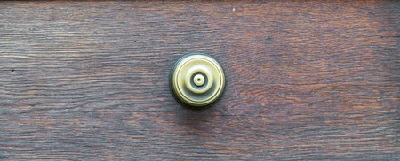Vintage door handle on a wooden front doorの写真素材