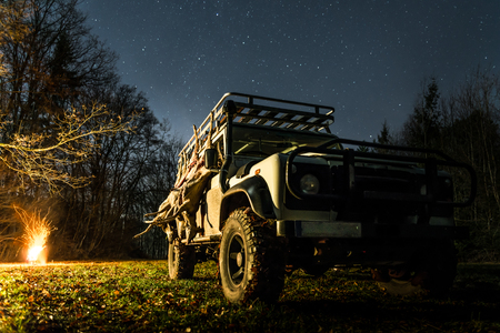 Hunting stretch with roe deer hanging on a off road vehicle