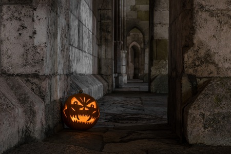 Halloween pumpkin in front of ancient stone wall of a church, Germanyの写真素材