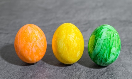 Colorful easter eggs in front of gray backgroundの写真素材