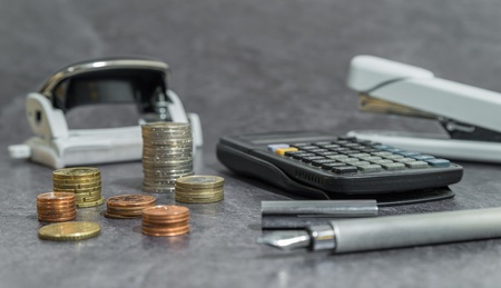 Money and office accessories on a deskの写真素材
