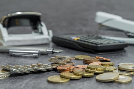 Money and office accessories on a deskの写真素材