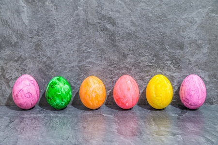 Colorful easter eggs in front of gray backgroundの写真素材