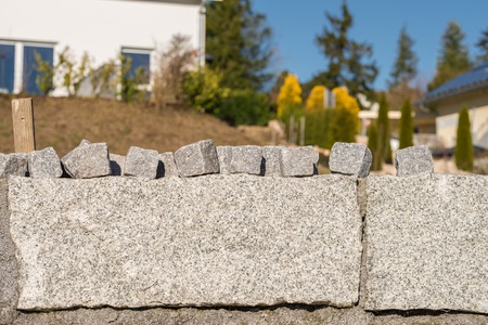 Granite wall and many small granite stones for road coating