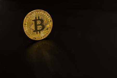 Gold coin bitcoin isolated on black background