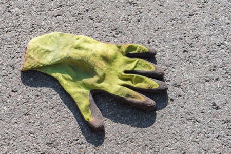 Yellow glove on a streetの写真素材