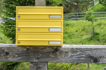 Yellow letterbox made of tin without a name in a rural area, Austriaの写真素材