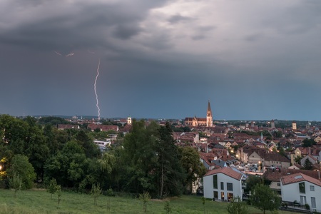 Dark clouds with lightning above lightning above Regensburg, Germanyの写真素材
