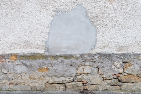 A damaged house wall and flaked exterior with a large hole, Germanyの写真素材