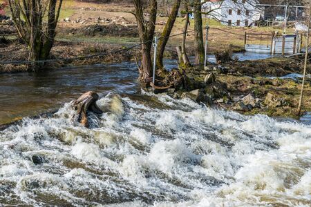 Grafenau, Bavaria, Germany, March 17, 2019, The river Grosse Ohe in Grafenau at high water in spring, Germanyのeditorial素材