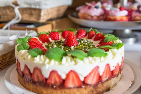 Close-up of a strawberry cream cake garnished with fresh strawberries, Germanyの写真素材