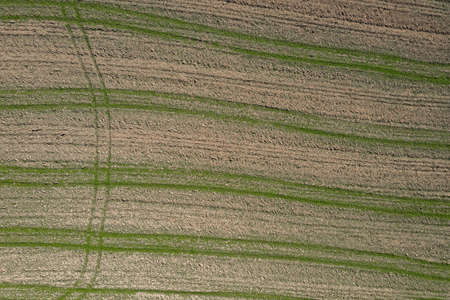 Picture of an aerial view with a drone of a field and field with tractor tracks in the Bavarian...