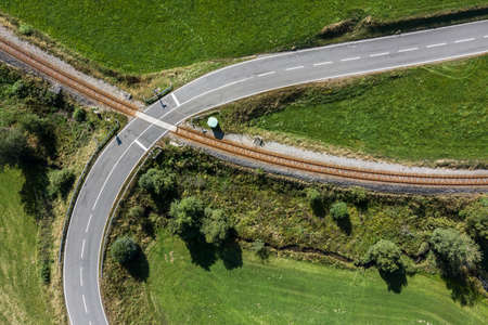 Picture of an aerial view with a drone of an unguarded railroad crossing in the Bavarian forest near...