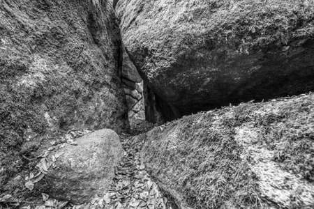 Entrance to the stone church in Thurmansbang - Old church built in a stone cave between erratic rocks and large stones in the Bavarian Forest, Germanyの写真素材