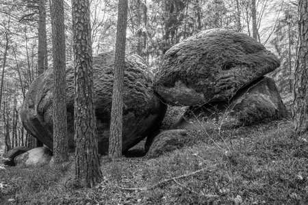 Ancient weathered megalithic granite rock formation with cave and breakthrough in Bavarian forest...