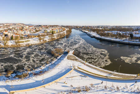 Panorama of Regensburg city in Bavaria with river Regen flowing into Danube in winter with ice snow...