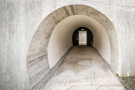 Detail of a concrete carved into the rock access to a modern elevator like that of a bunker in the mountain with thick walls, Germanyの写真素材