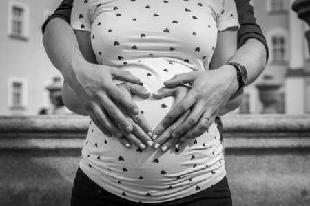 Creative baby bump photo shoot with pregnant mother and fatherの写真素材