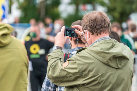 Regensburg, Bavaria, Germany, August 18, 2021, A man in the audience takes a picture of campaign...