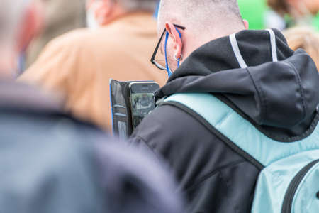 Regensburg, Bavaria, Germany, August 18, 2021, A man in the audience takes a picture of campaign...
