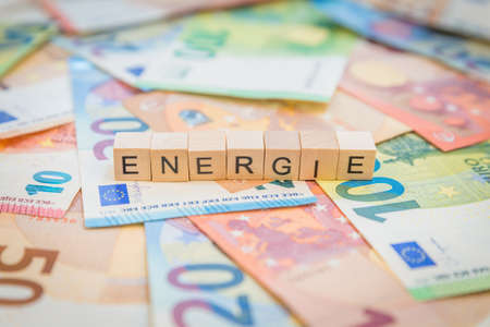 The word Energie - in German for Energy - written on banknotes Euro notes with wooden cubeの写真素材