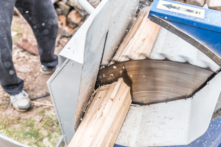 Close up of circular saw with logs for wood cutting, Germanyの写真素材