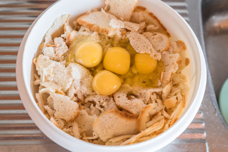 Eggs separated yolks from whites in a bowl with breadcrumbs to make bread dumplings, Germany