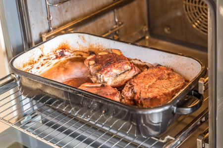 Real hearty homemade roast pork in a roaster casserole in the oven, Germanyの写真素材