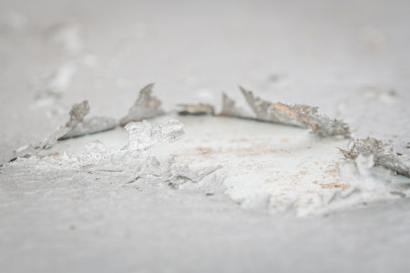 Close-up of a cracked and burst layer of paint on a tin roof, Germany