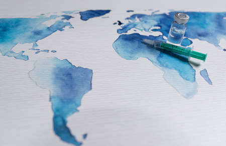 Vaccination preparation against global pandemic, injection on wold map background