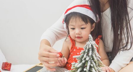 Happy family mother and baby playing home on Christmas holidays.の写真素材