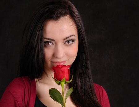 Attractive model posing in studio with roseの写真素材