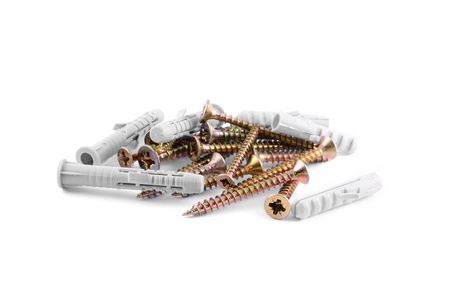 Pile of wood screws with dowel isolated on white background 