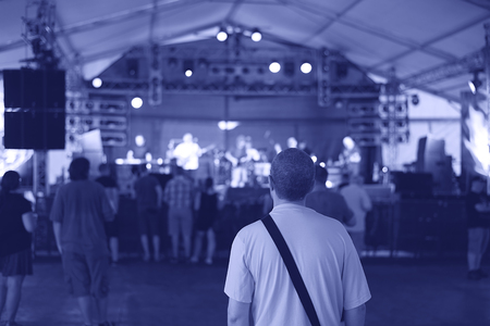 Silhouettes of concert crowd in front of bright stage lights, detailの写真素材