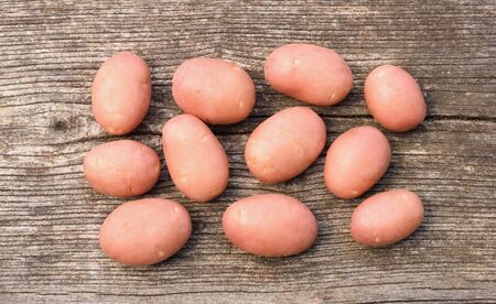 Potatoes on a wooden backgroundの写真素材