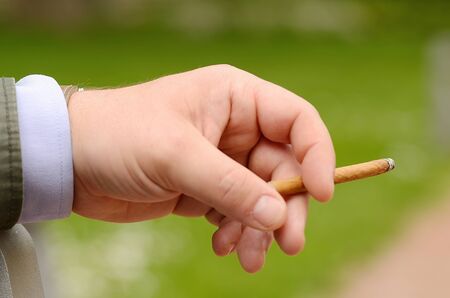 Male hand holding a cigarette, detailの写真素材