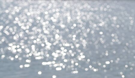 Abstract bokeh background on a water surfaceの写真素材