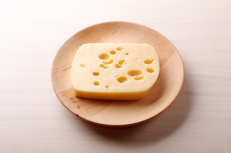 Cheese on wooden plateの写真素材