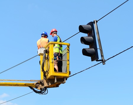Workers the updated traffic lights on the latest LEDの写真素材