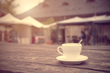 Cup of coffee on a wooden background. Vintage viewの写真素材