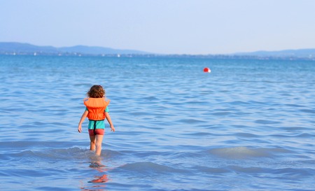 Little girl goes into the water for her ballの写真素材