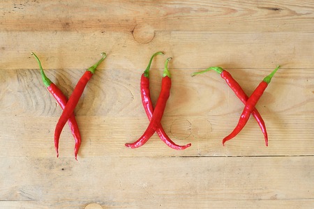 Hot xxx made with chili peppers on wooden backgroundの写真素材