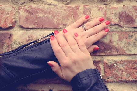 Soft photo of woman hand on brick wallの写真素材
