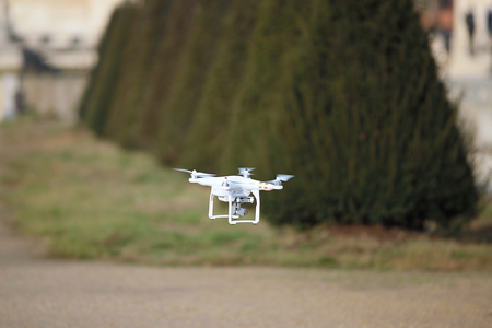 Flying drone with camera in the parkの写真素材