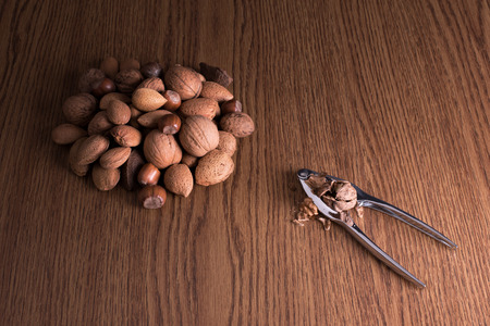 Different types of nuts on wooden background